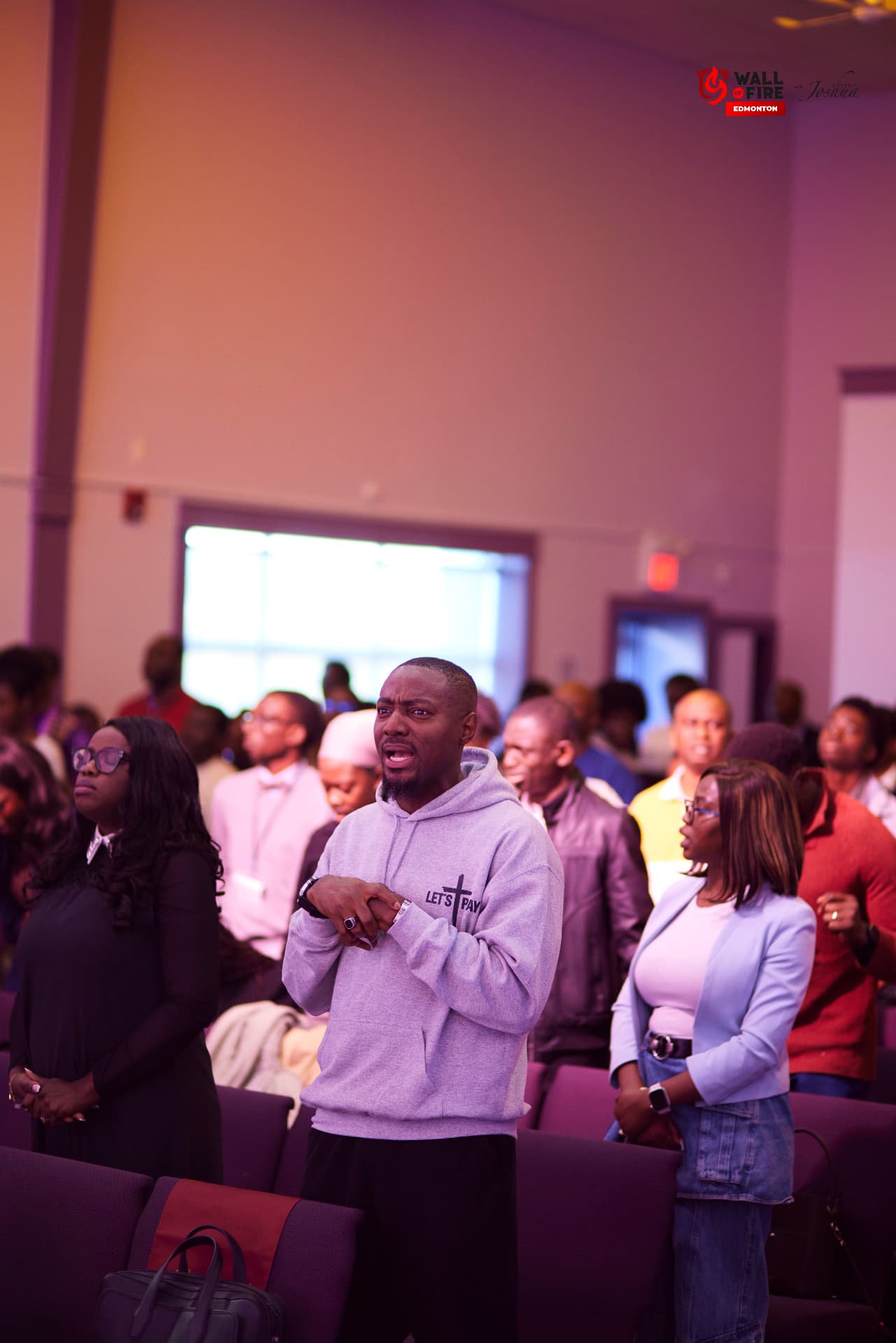 A man praying among the crowd